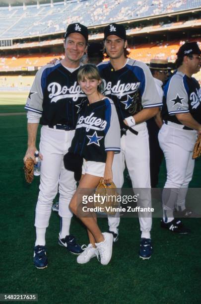 Stephen Collins, Barry Watson and Beverly Mitchell in baseball attire on the pitch, United States, circa 1990s.