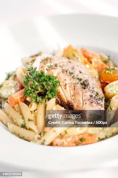 fried chicken breast with penne and saute vegetables pasta dish,romania - chicken saute stock pictures, royalty-free photos & images