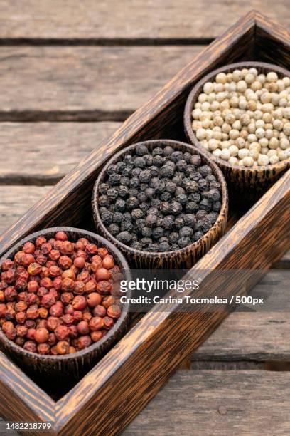 organic white red and black pepper corns in wood display,romania - blad stock pictures, royalty-free photos & images
