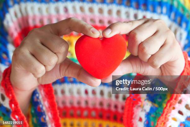 midsection of woman holding heart shape,romania - kind 個照片及圖片檔