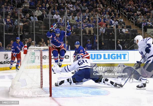 Kaapo Kakko of the New York Rangers scores a second period goal against Joseph Woll of the Toronto Maple Leafs as he is screened by Artemi Panarin at...