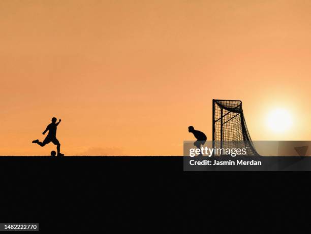 two players playing football before sunset - soccer field outline stock pictures, royalty-free photos & images