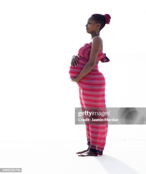 traditional african woman, pregnant posing on white blackground - black blackground stock pictures, royalty-free photos & images