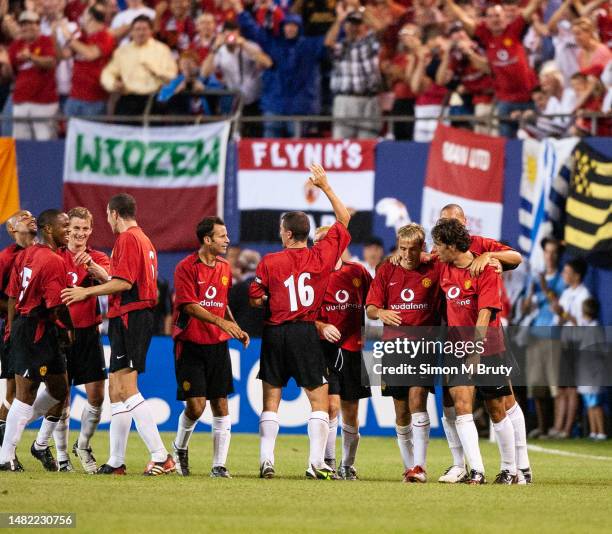 Ruud Van Niselrooy is congratulated by Phil Neville, Rio Ferdinand, Ryan Giggs and Ole Gunnar Solskjaer and Roy Keane of Manchester United during...