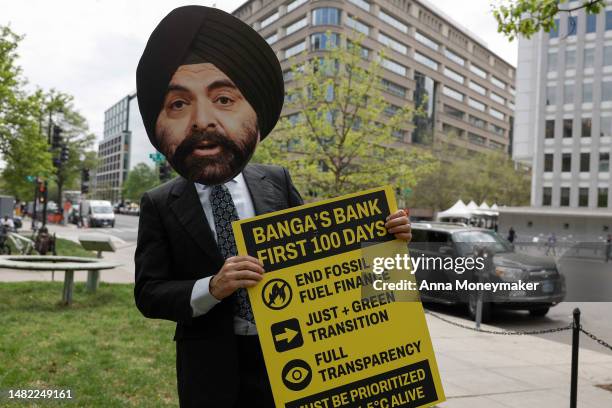 Climate activist dressed as Ajay Banga, the vice chairman at General Atlantic, protests outside of the World Bank and International Monetary Fund...