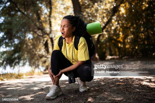 woman are injured during hiking - twisted ankle stock pictures, royalty-free photos & images