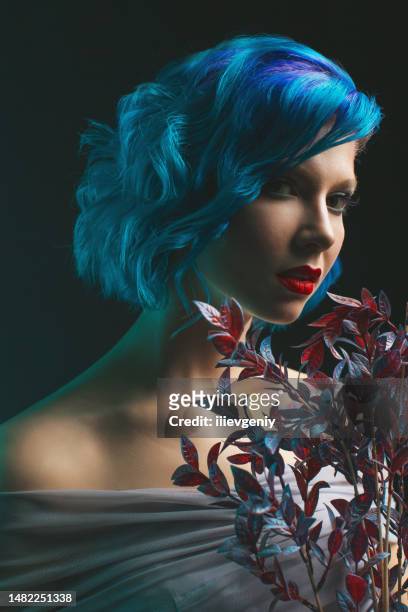 girl with blue dyed hair in studio on black background - girl short hair stock pictures, royalty-free photos & images