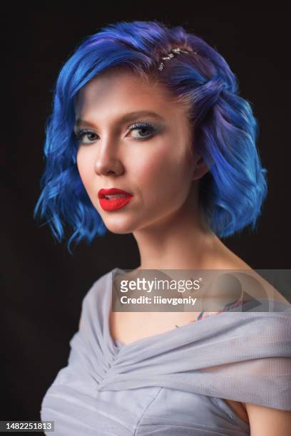 girl with blue dyed hair in studio on black background - blue hair stock pictures, royalty-free photos & images