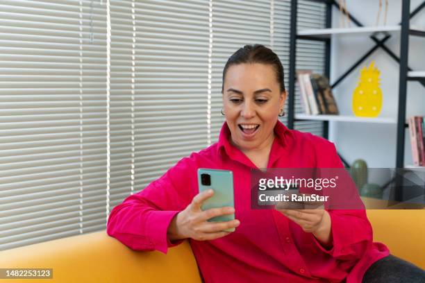 woman enjoying at home and buying online - women reservation stock pictures, royalty-free photos & images