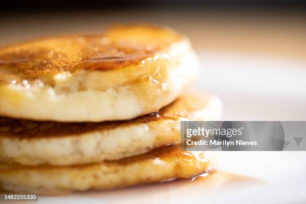 delicious maple syrup over fluffy stack of pancakes - "marilyn nieves" stock pictures, royalty-free photos & images
