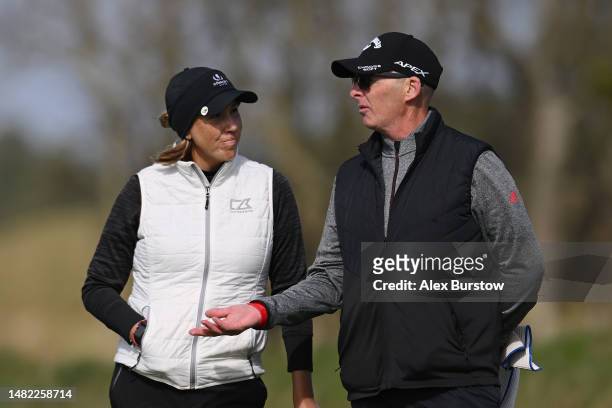 Whitney Hillier of Australia talks with her caddie and former football referee, Mike Dean on the eighteenth green during The Rose Ladies Series at...
