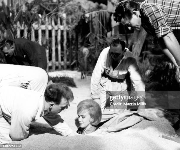 In this handout from United Artists, American comedienne, actress, singer and businesswoman, Edie Adams talks with personnel on the set of the 1963...