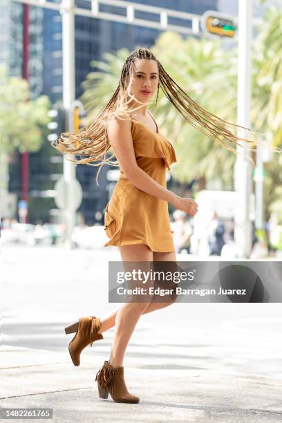 summer happiness of a latina woman with her hair braided in the air - アクション映画 ストックフォトと画像