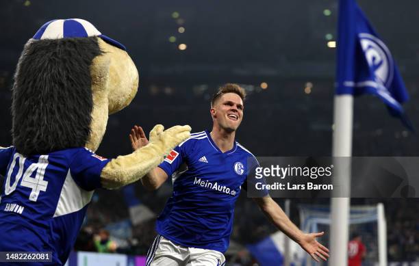 Marius Bulter of Schalke celebrates scoring his teams fourth goal of the game during the Bundesliga match between FC Schalke 04 and Hertha BSC at...