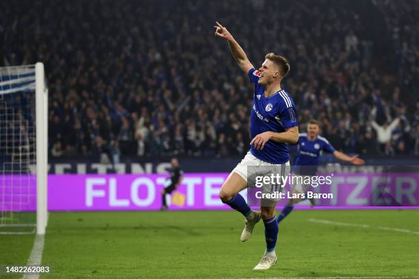 Marius Bulter of Schalke celebrates scoring his teams fourth goal of the game during the Bundesliga match between FC Schalke 04 and Hertha BSC at...