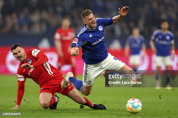 Simon Terodde of Schalke is fouled by Filip Uremovic of Hertha BSC during the Bundesliga match between FC Schalke 04 and Hertha BSC at Veltins-Arena...