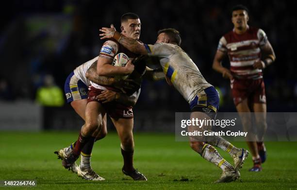 Brad O'Neill of Wigan is tackled by Daryl Clark of Warrington during the Betfred Super League between Warrington Wolves and Wigan Warriors at The...