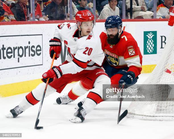 Radko Gudas of the Florida Panthers defends against Sebastian Aho of the Carolina Hurricanes at the FLA Live Arena on April 13, 2023 in Sunrise,...