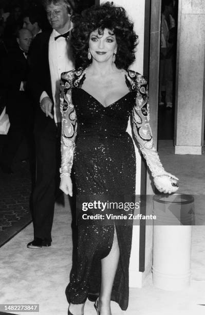 Joan Collins and husband Peter Holm attend an awards ceremony in Los Angeles, California, United States, circa 1980s.