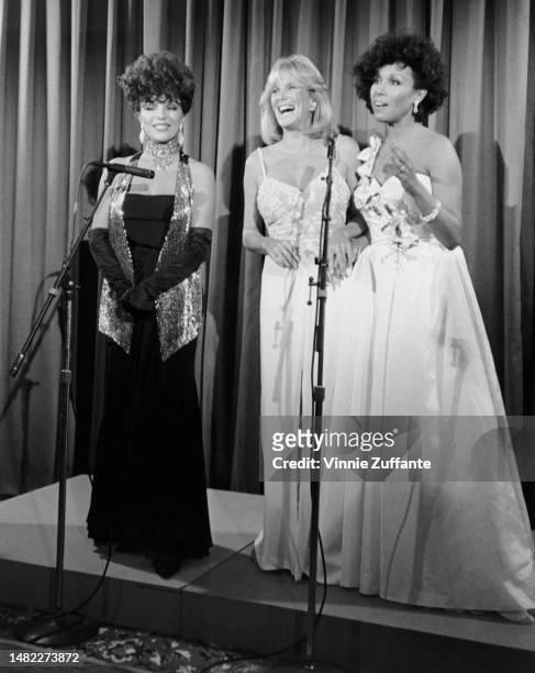 Joan Collins, Linda Evans and Diahann Carroll at the 36th Annual Emmy Awards, Los Angeles, California, United States, 23rd September 1984 .