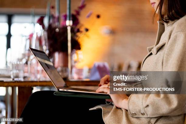 close-up of wedding event planner working on laptop. - computer wedding stock pictures, royalty-free photos & images
