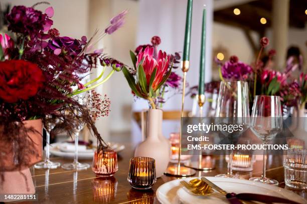 luxury wedding event table set with flower decorations and candles. - wedding table setting stock pictures, royalty-free photos & images
