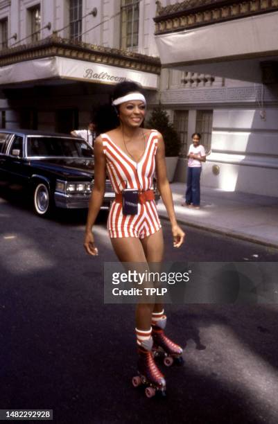 American singer and actress Diana Ross, with her Walkman, smiles during her tour of New York City on her roller skates in New York, New York, circa...