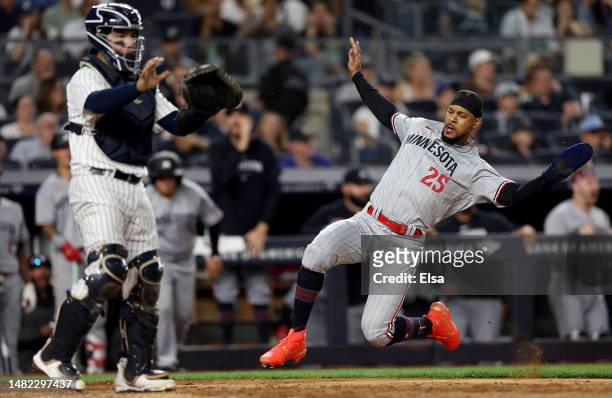 Byron Buxton of the Minnesota Twins scores on a double from teammate Carlos Correa in the eighth inning as Jose Trevino of the New York Yankees...
