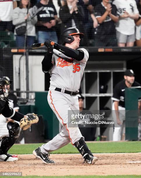 Adley Rutschman of the Baltimore Orioles hits a three-RBI double during the seventh inning against the Chicago White Sox at Guaranteed Rate Field on...