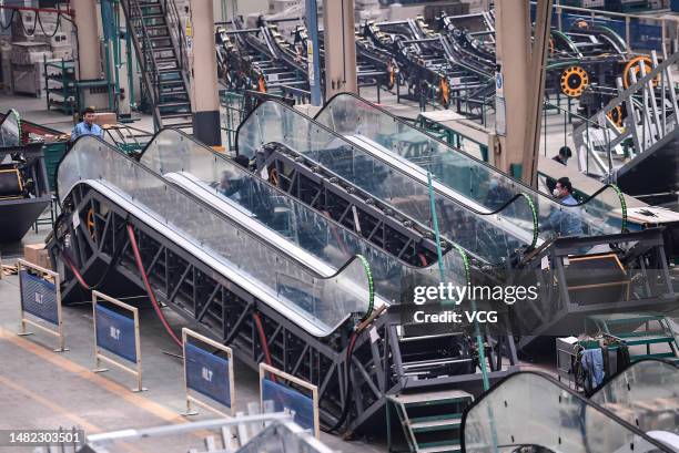 Employees manufacture escalators at Yuanda Enterprise Group on April 14, 2023 in Shenyang, Liaoning Province of China.