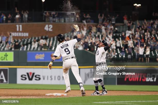 Nick Maton of the Detroit Tigers celebrates his game winning 11th inning walk off three run home run with first base coach Alfredo Amezaga to beat...