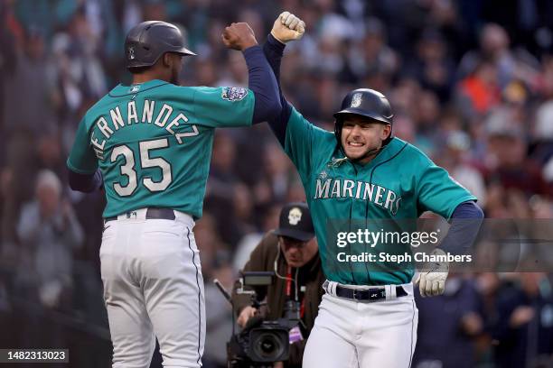 Jarred Kelenic of the Seattle Mariners celebrates his two run home run with Teoscar Hernandez during the second inning against the Colorado Rockies...