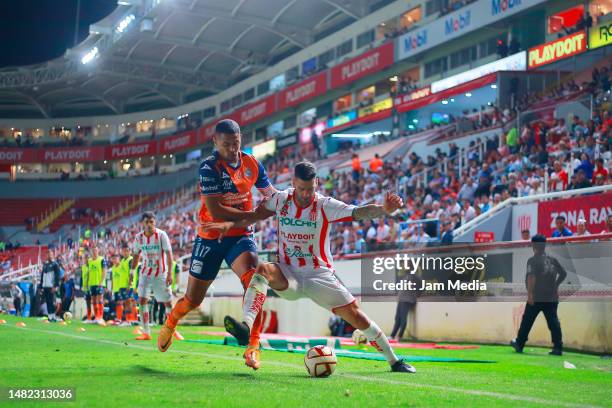 Emanuel Gularte of Puebla fights for the ball with Edgar Mendez of Necaxa during the 15th round match between Necaxa and Puebla as part of the Torneo...