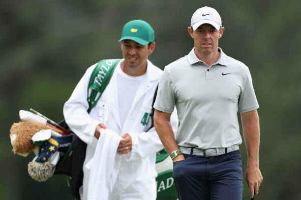 Rory McIlroy of Northern Ireland and caddie Harry Diamond walk up the 18th green during the second round of the 2023 Masters Tournament at Augusta...