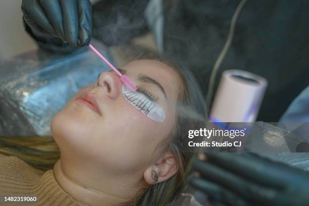 esthetician finishing procedure for eyelash extension - femininity stock pictures, royalty-free photos & images