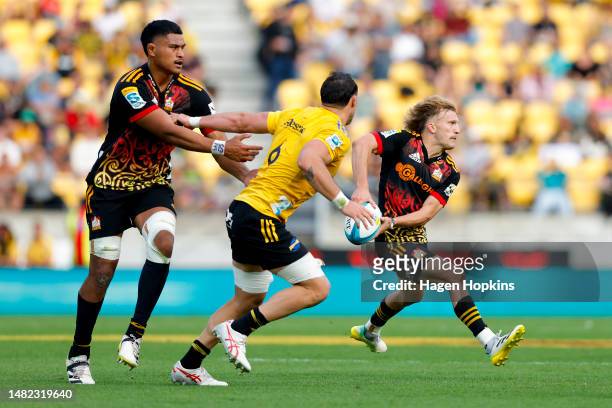 Damian McKenzie of the Chiefs passes during the round eight Super Rugby Pacific match between Hurricanes and Chiefs at Sky Stadium, on April 15 in...