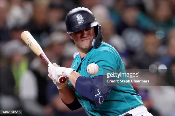 Ty France of the Seattle Mariners is hit by a pitch during the sixth inning against the Colorado Rockies at T-Mobile Park on April 14, 2023 in...