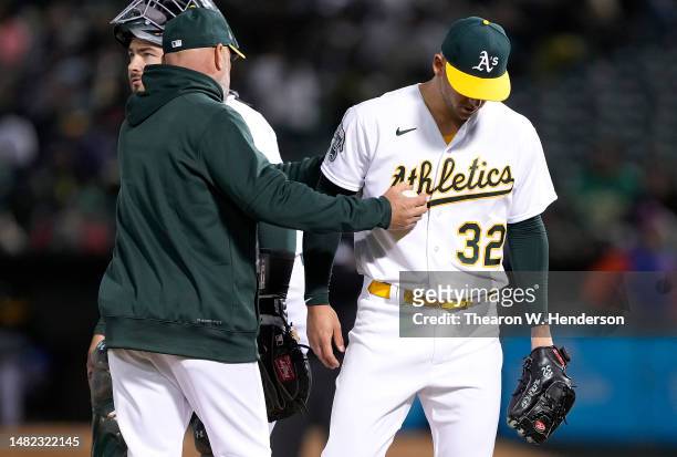 Manager Mark Kotsay of the Oakland Athletics takes the ball from starting pitcher James Kaprielian taking Kprielian out of the game against the New...