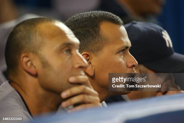 Derek Jeter of the New York Yankees and Alex Rodriguez look on from the top step of the dugout against the Toronto Blue Jays during MLB game action...