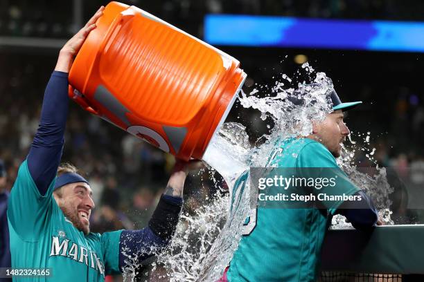 Tom Murphy douses Jarred Kelenic of the Seattle Mariners with water after the game against the Colorado Rockies at T-Mobile Park on April 14, 2023 in...