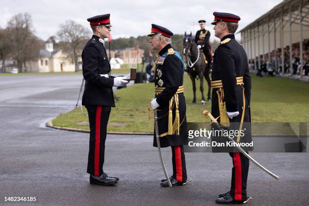 Britain's King Charles III presents an award for best International Cadet to Cadet, B. P. Ritchey from the USA during the 200th Sovereign's parade at...
