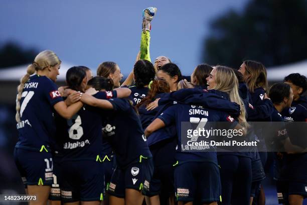 Victory goalkeeper Casey Dumont raises her fist to celebrate with teammates after winning the penalty shootout to decide the A-League Women's Semi...