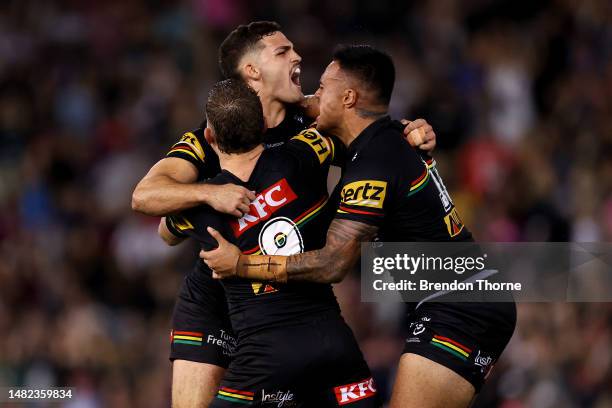 Nathan Cleary of the Panthers celebrates with team mates Mitch Kenny and Spencer Leniu after kicking the winning field goal in golden point during...