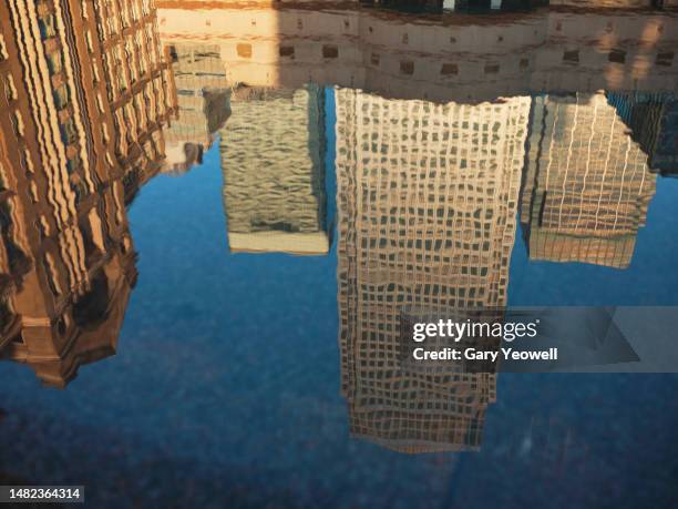 reflection in water of low angle view of skyscrapers in london - reflection pool stock pictures, royalty-free photos & images