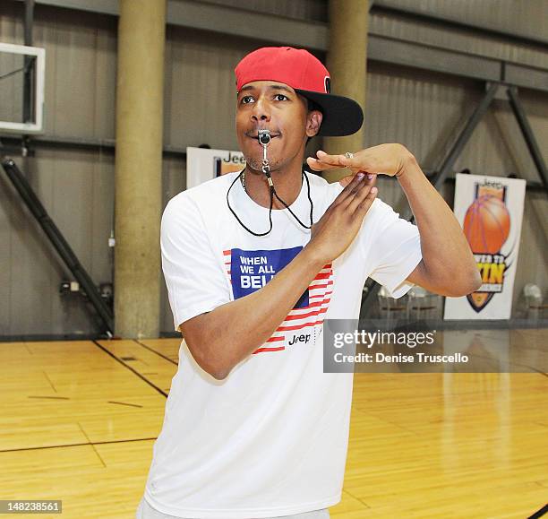 Nick Cannon interacts with kids from the Jalen Rose Leadership Academy Clinic at Impact Basketball on July 12, 2012 in Las Vegas, Nevada.