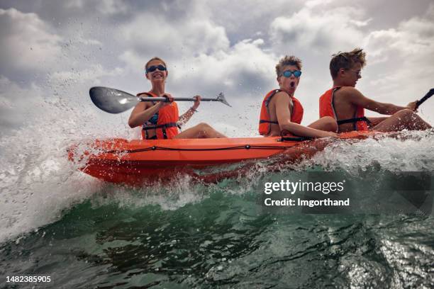 teenagers enjoying kayaking in sea on summer day - life jacket photos stock pictures, royalty-free photos & images