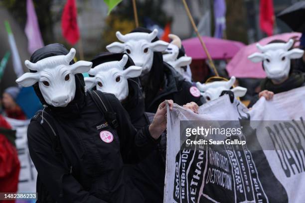 Supporters of the activists groups Extinction Rebellion and Animal Rebellion, including some dressed as cows, protest against declining biodiversity...