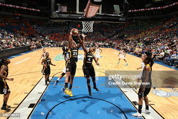 Glory Johnson and Amber Holt of the Tulsa Shock go for the rebound in the WNBA game against the Minnesota Lynx on July 12, 2012 at Target Center in...