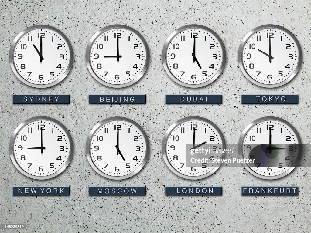 International time zone clocks on a concrete wall