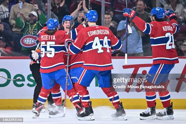 Lucas Condotta of the Montreal Canadiens celebrates his first career NHL goal in his first NHL game with teammates during the first period against...